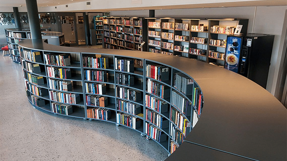 BCI Libraries Frontline Curve Shelving units featuring a distinctive winding design.